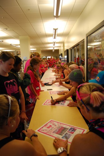 The girls getting their posters signed by Olympic, World Champs and National medalists (photo: Nancye Rahn)
