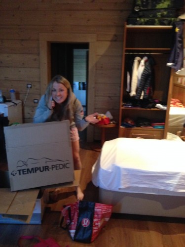 Holly on the phone with her husband while getting a tempur-pedic cover set up on the bed!