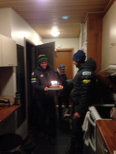 Simi bringing out Andy's birthday cake! We celebrated in Ruka. 