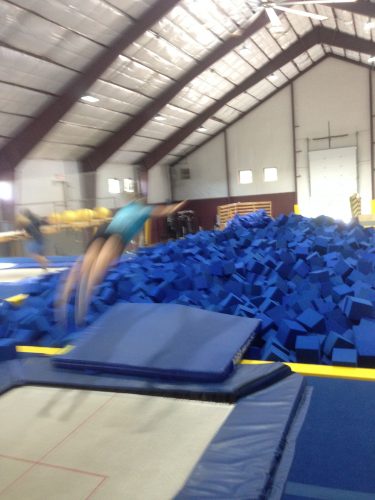 Taking a dive into the foam pit after balance training on the trampolines at the SMS air awareness center. (photo from Cork)